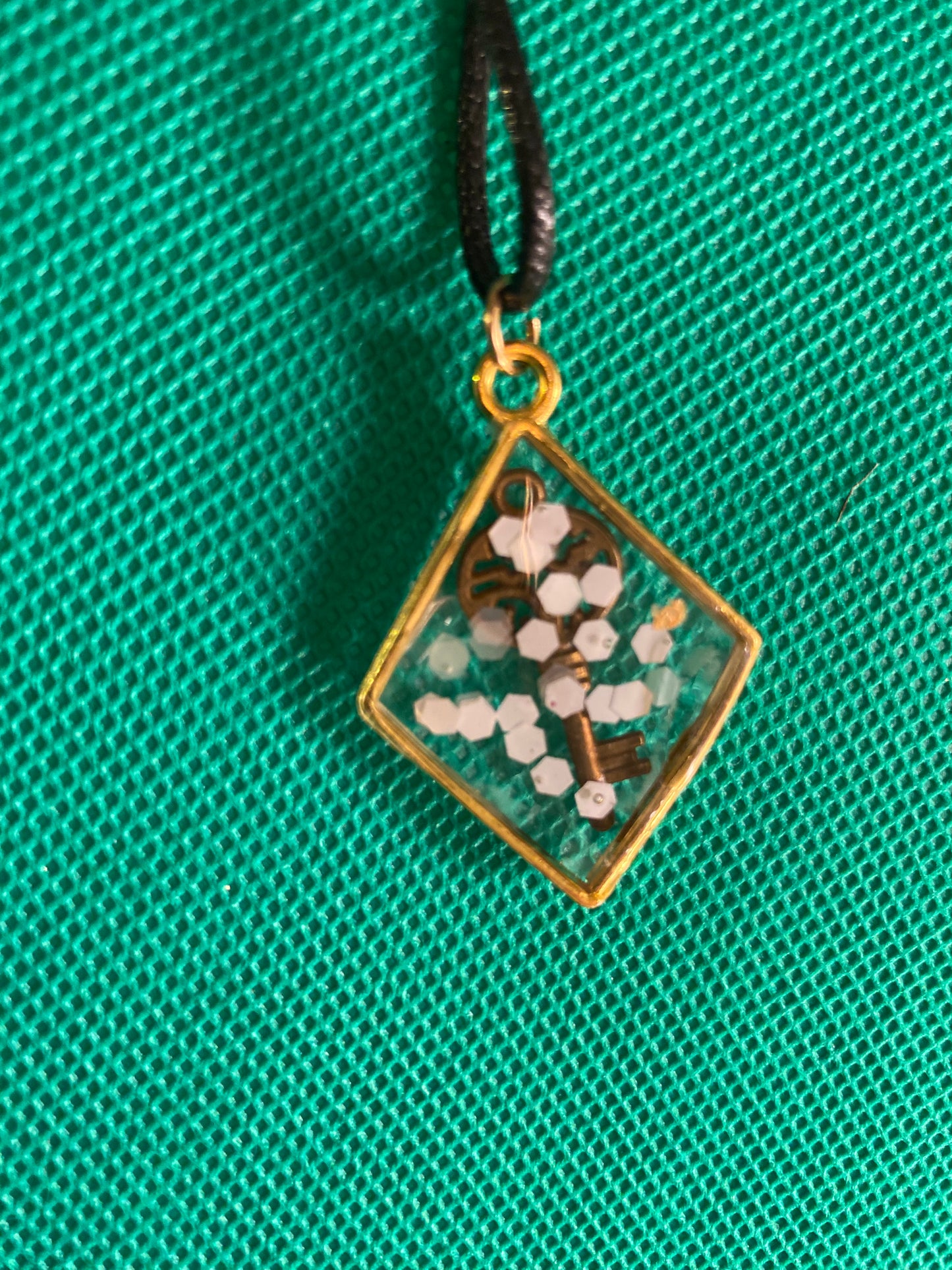 Key and white flakes in a diamond bezel