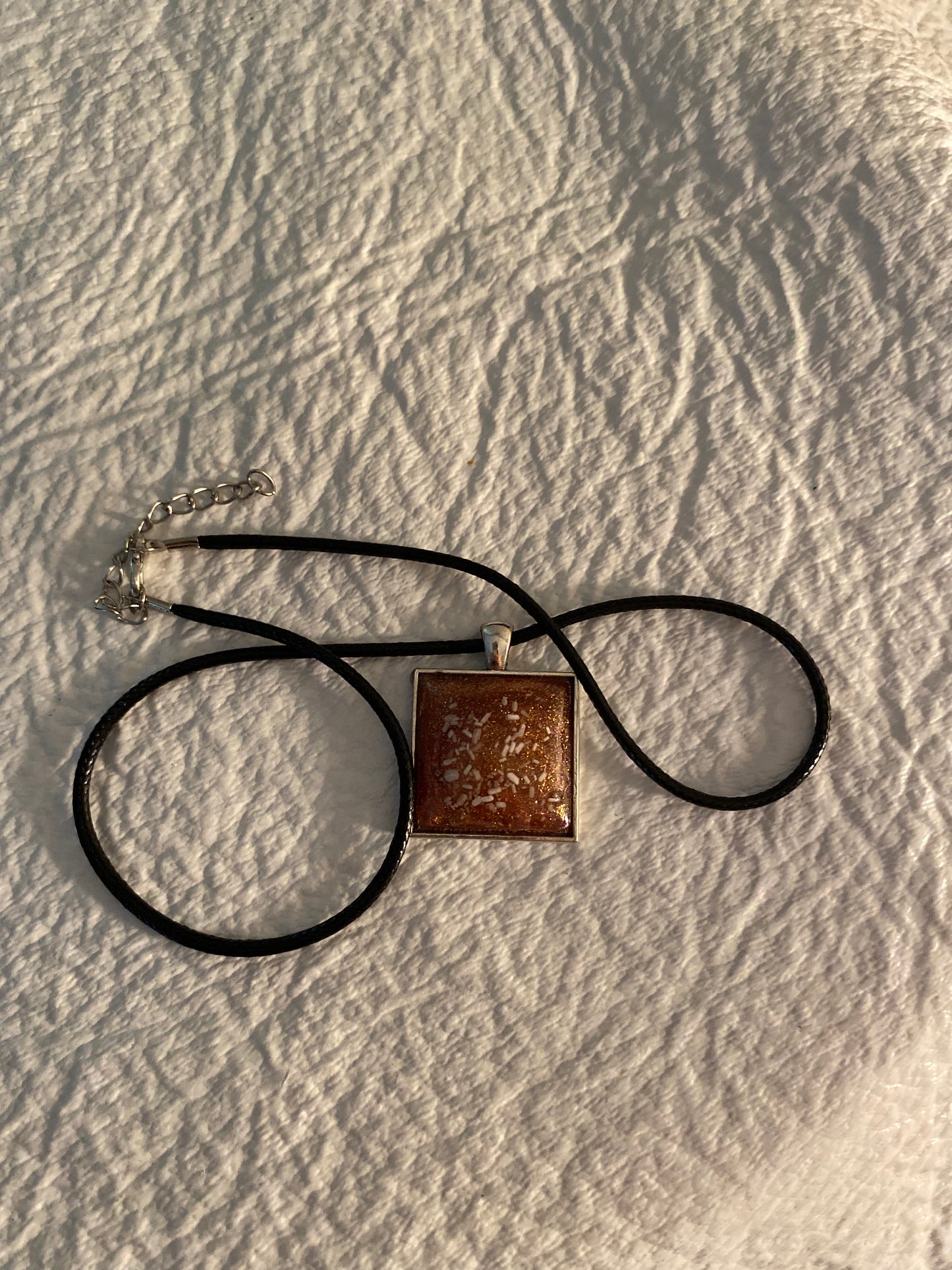 Gold and white flakes in a square necklace