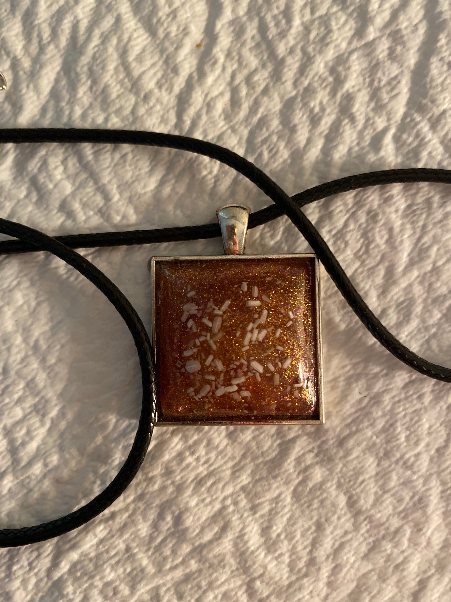 Gold and white flakes in a square necklace