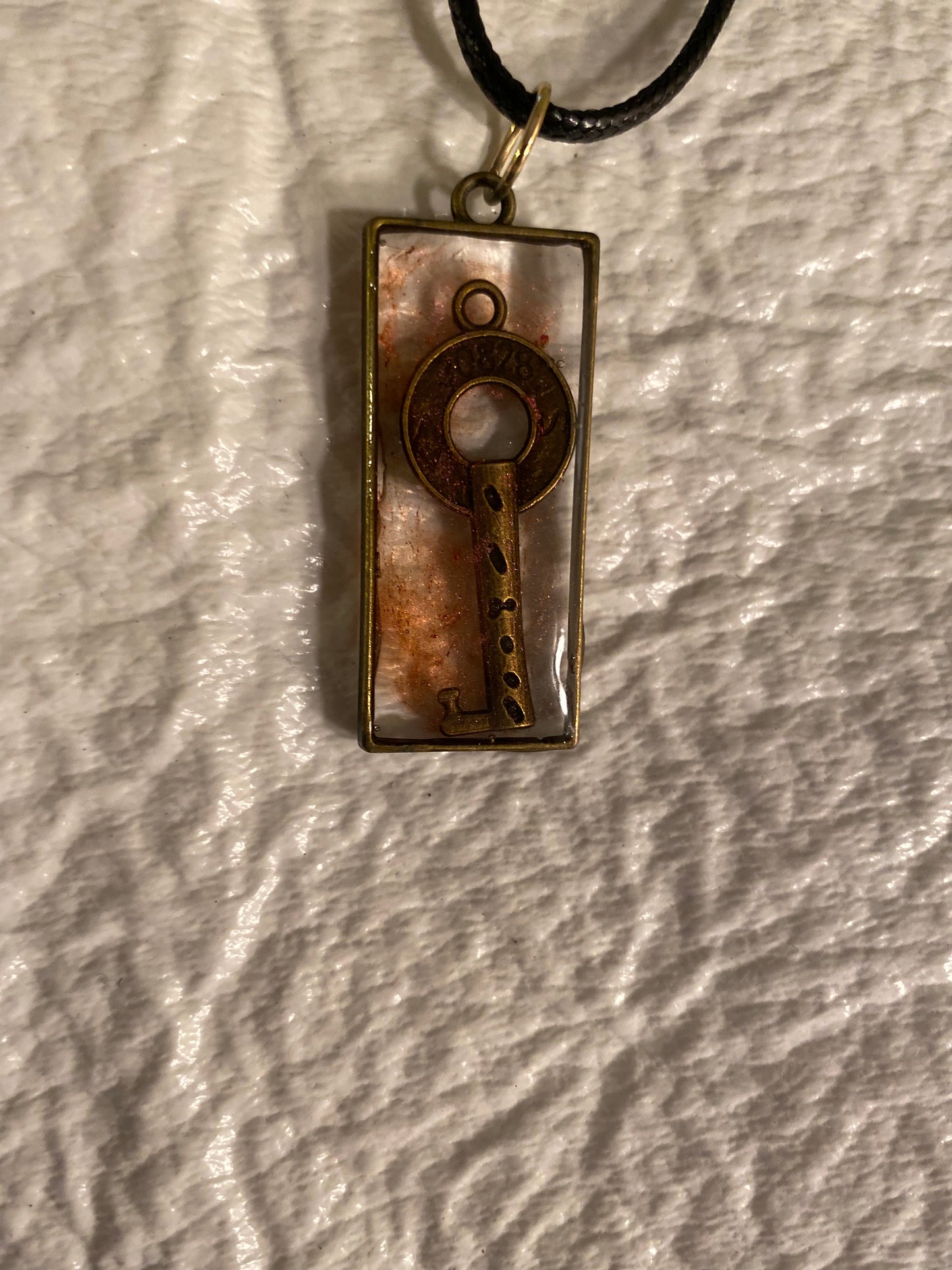 Key in rectangular bezel pendant