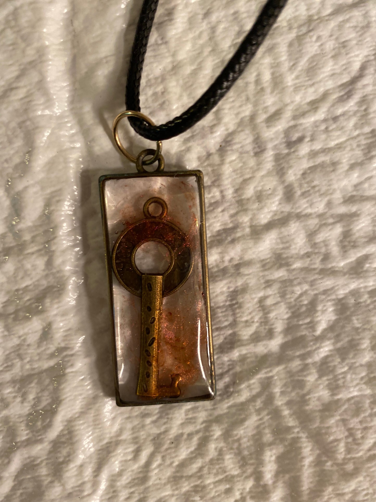 Key in rectangular bezel pendant