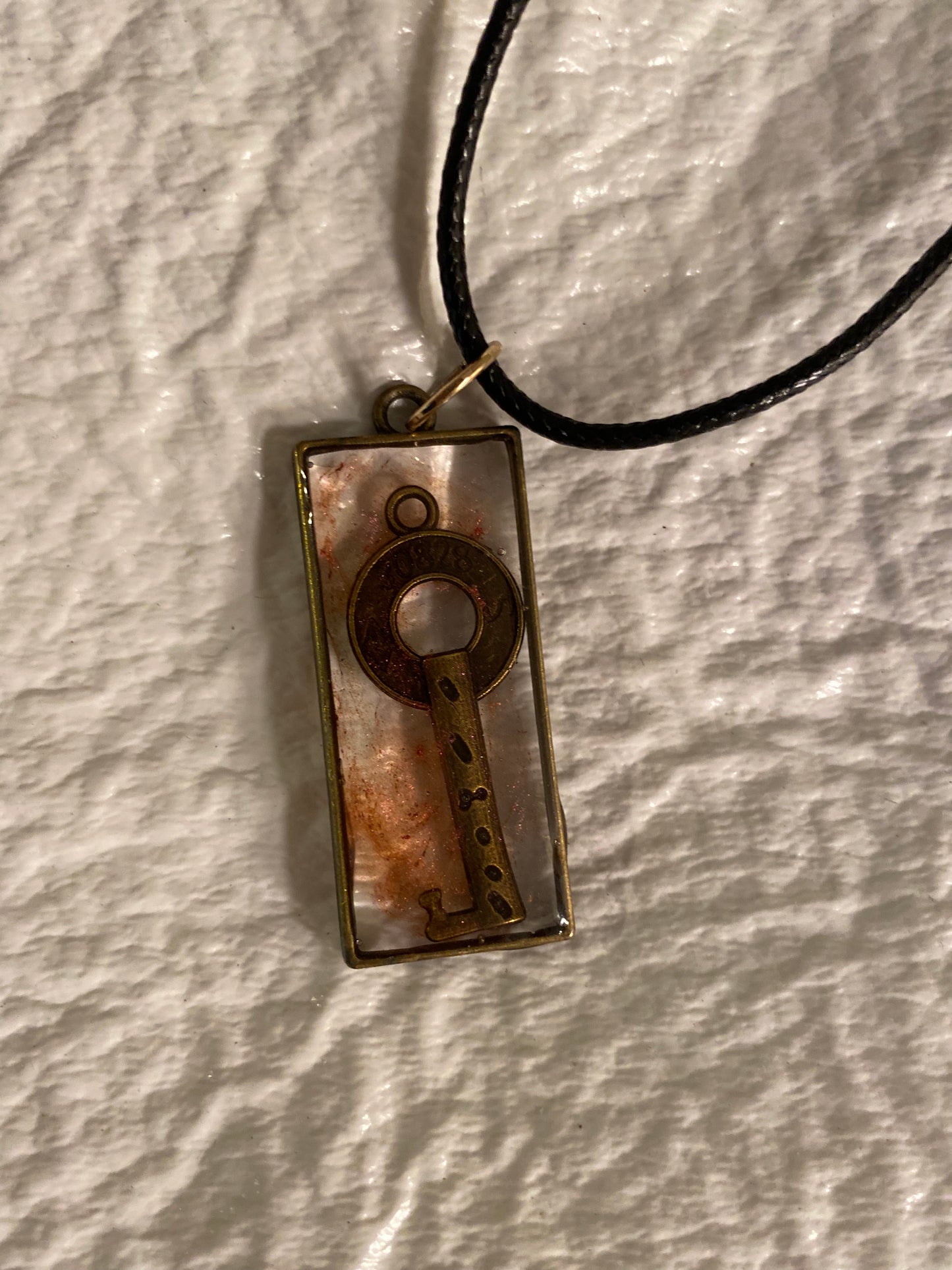 Key in rectangular bezel pendant