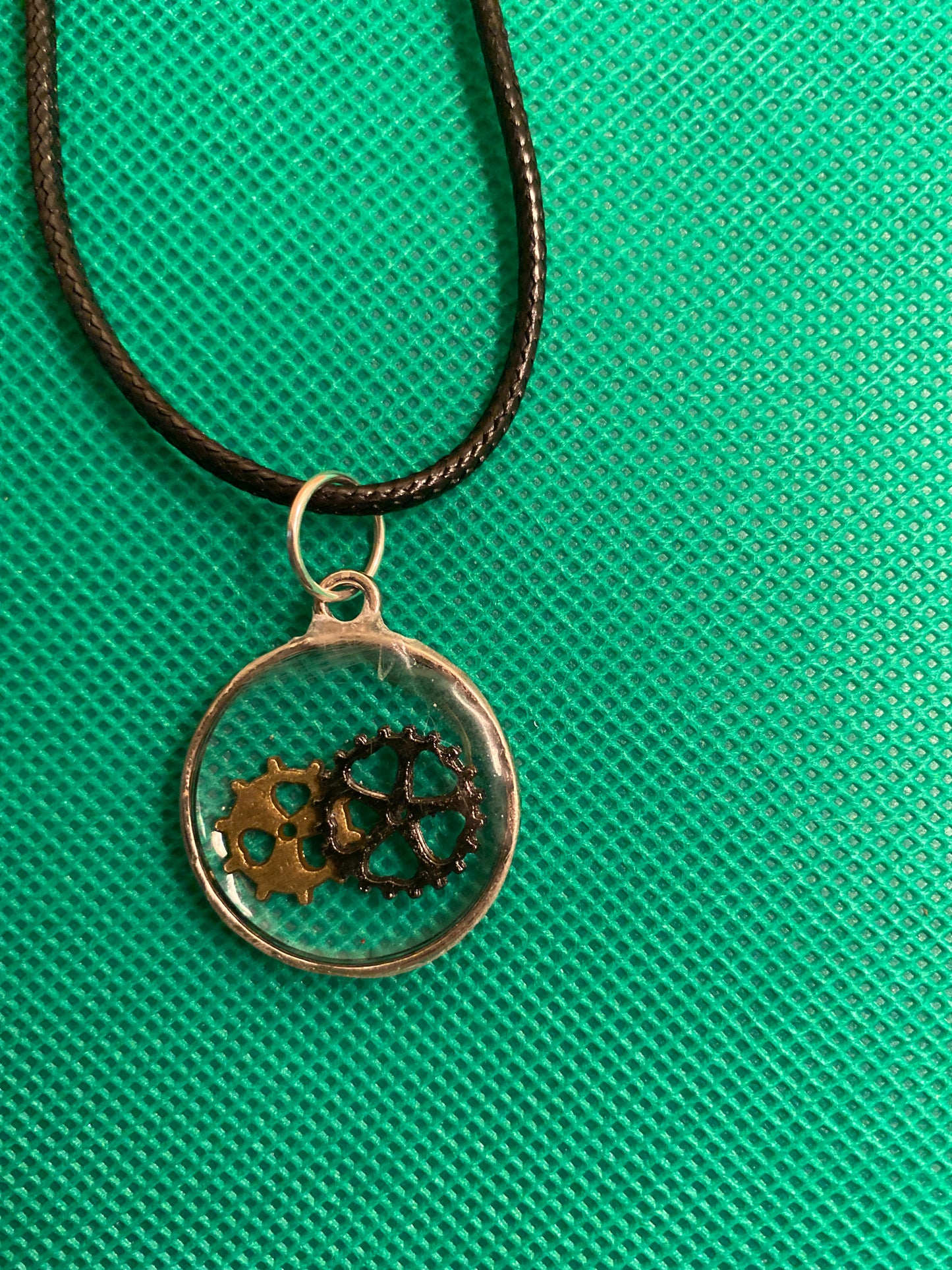 Time in a round bezel pendant